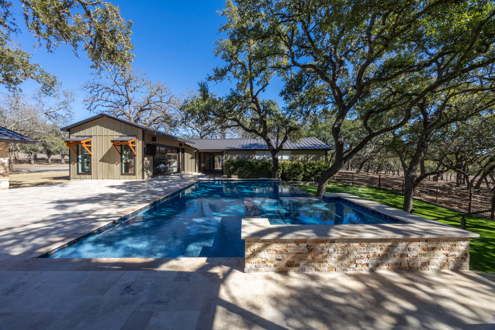 Pool with natural stone accents and lush greenery